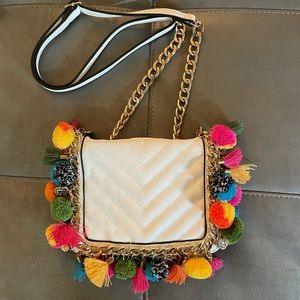 White mini bag with colorful tassels and gold accents